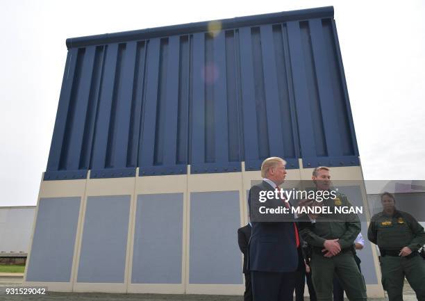 President Donald Trump inspects border wall prototypes in San Diego, California on March 13, 2018. / AFP PHOTO / MANDEL NGAN