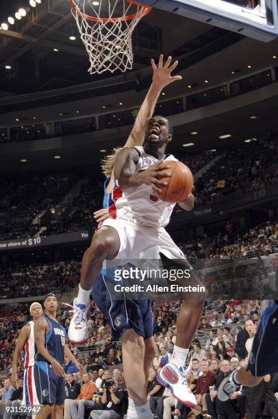 Rodney Stuckey of the Detroit Pistons goes up for a shot against Dirk Nowitzki of the Dallas Mavericks during the game at the Palace of Auburn Hills...