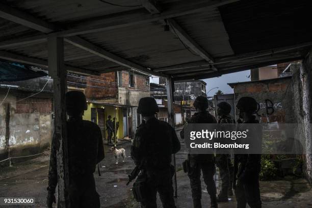 Soldiers stand guard in the Vila Kennedy neighborhood in Rio de Janeiro, Brazil, on Thursday, March 8, 2018. As public safety remains a top concern...