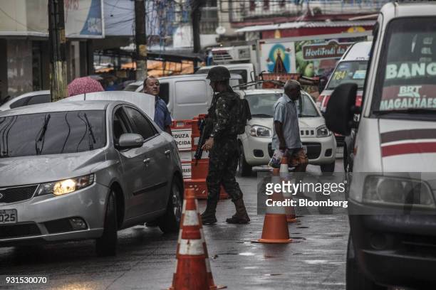 Solider inspects vehicles in the Vila Kennedy neighborhood in Rio de Janeiro, Brazil, on Thursday, March 8, 2018. As public safety remains a top...