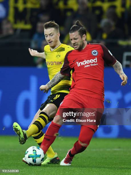 Marco Russ of Eintracht Frankfurt and Marco Reus of Borussia Dortmund compete for the ball during the Bundesliga match between Borussia Dortmund and...