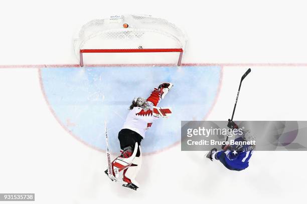Jocelyne Lamoureux of the United States scores a goal against Shannon Szabados of Canada in a shootout to win the Women's Gold Medal Game on day...