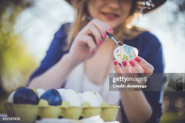 close-up of a woman decorating easter eggs with decoupage technique - decoupage stock pictures, royalty-free photos & images