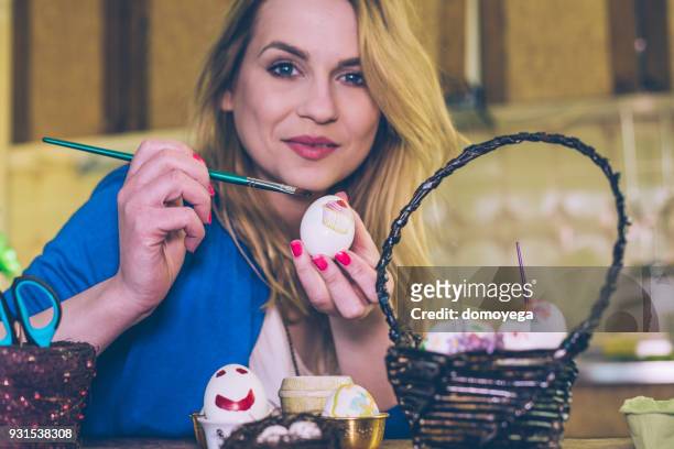 woman decorating easter eggs for holidays at home - decoupage stock pictures, royalty-free photos & images