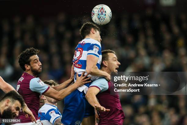 Queens Park Rangers' Pawel Wszolek wins a ball in the air under pressure from Aston Villa's Neil Taylor and John Terry during the Sky Bet...