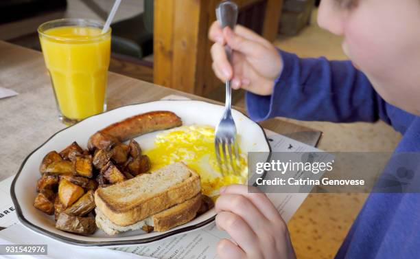 11 year old boy eating breakfast at diner - carbohydrate food type stock pictures, royalty-free photos & images