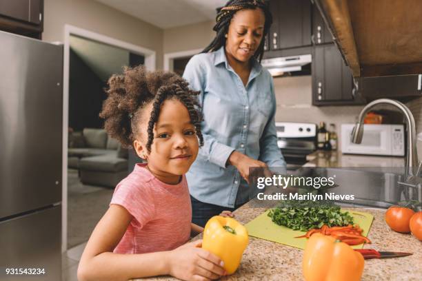 mother and daughter making a salad - marilyn nieves stock pictures, royalty-free photos & images