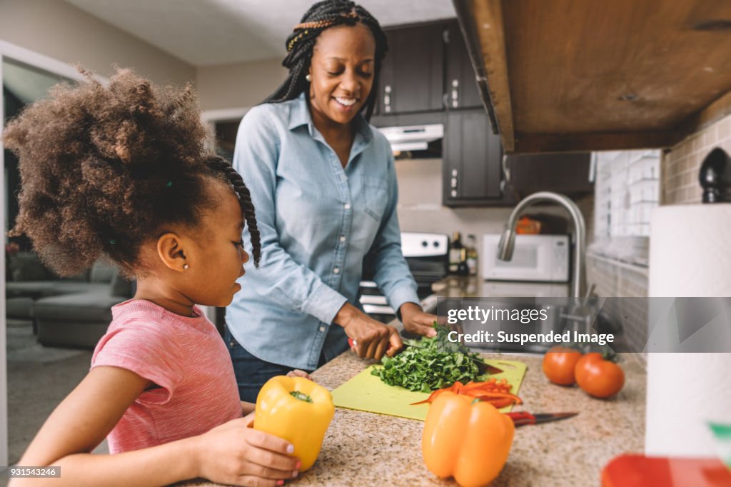 Mother and daughter making a salad