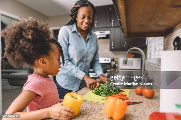 mother and daughter making a salad - mum preparing food stock pictures, royalty-free photos & images