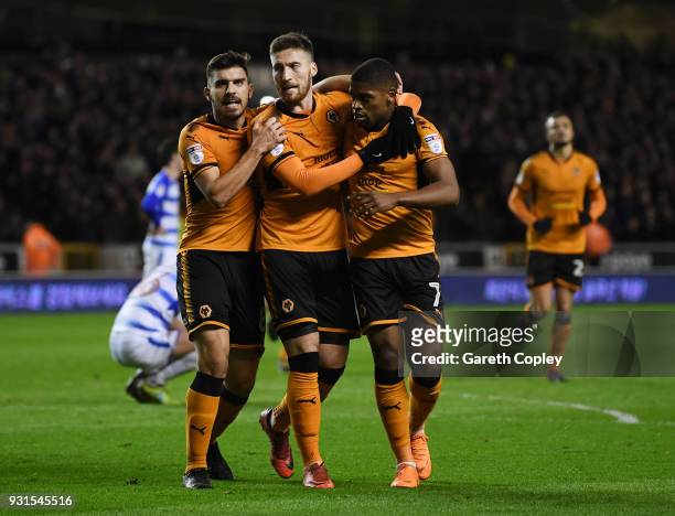 Matt Doherty of Wolverhampton Wanders is congratulated on scoring the opening goal by Ruben Neves and Ivan Cavaleiro during the Sky Bet Championship...