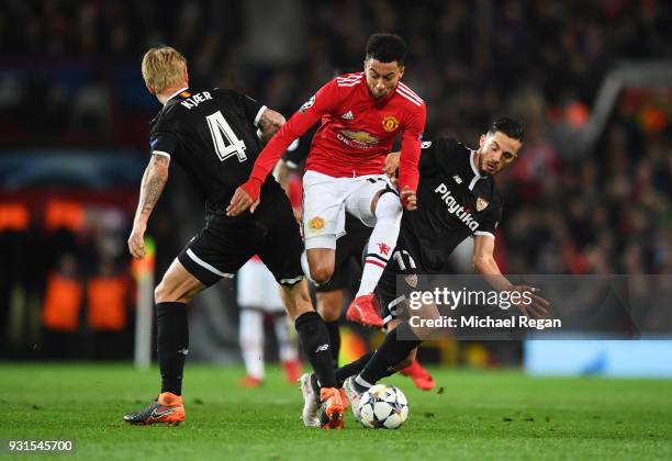 Jesse Lingard of Manchester United takes on Simon Kjaer and Pablo Sarabia of Sevilla during the UEFA Champions League Round of 16 Second Leg match...