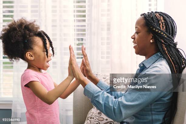 playing patty cake - clapping game stock pictures, royalty-free photos & images