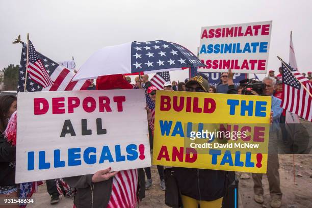 Supporters of U.S. President Donald Trump rally for the president during his visit to see the controversial border wall prototypes on March 13, 2018...