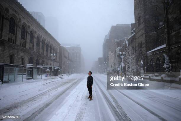 Fynn Schwichtenberg, from Natick, observes the blizzard on Boylston Street near the Boston Public Library during the third nor'easter storm to hit...