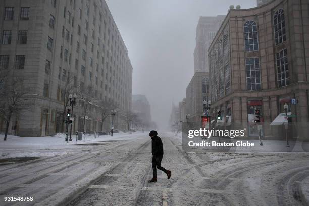 Pedestrian crosses Boylston Street at Clarendon in Boston during the third nor'easter storm to hit the region in two weeks on March 13, 2018.