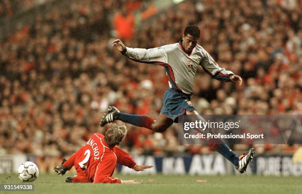 Patrick Kluivert of Barcelona is tackled by Stephane Henchoz of Liverpool during a UEFA Cup Semi Final 2nd leg at Anfield on April 19, 2001 in...
