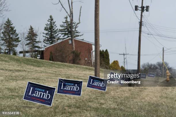 Campaign signs for Conor Lamb, Democratic candidate for the U.S. House of Representatives, are displayed on the side of a road in McKeesport,...