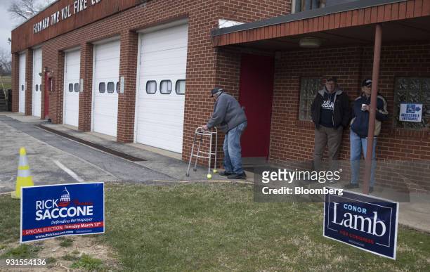 Residents stand outside the Forward Township Volunteer Fire Department polling location in Forward Township, Pennsylvania, U.S., on March 13, 2018....