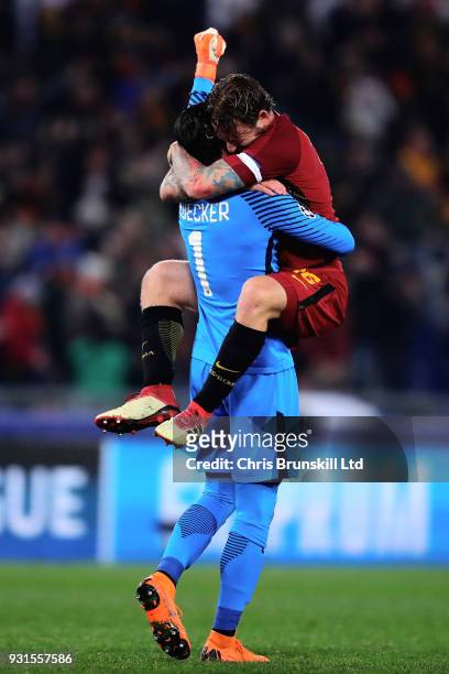 Alisson of AS Roma celebrates with teammate Daniele De Rossi after his side scored the opening goal during the UEFA Champions League Round of 16...