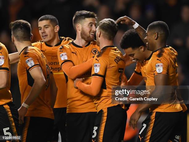 Matt Doherty of Wolverhampton Wanders is congratulated on scoring the third goal during the Sky Bet Championship match between Wolverhampton...