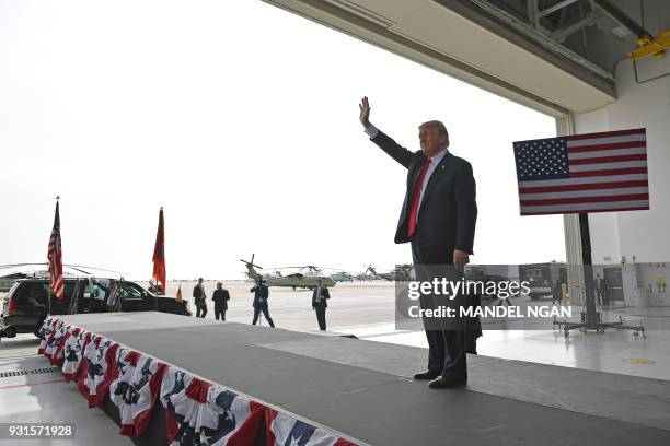 President Donald Trump waves after speaking to military personnel at Marine Corps Air Station Miramar in San Diego, California on March 13, 2018. /...