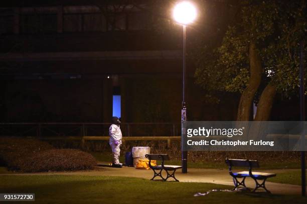 Police officers in forensics suits and protective masks work at the scene of the poisoning of Sergei Skripal on March 13, 2018 in Salisbury, England....