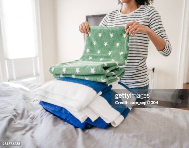 woman folding towels - mixing stock pictures, royalty-free photos & images