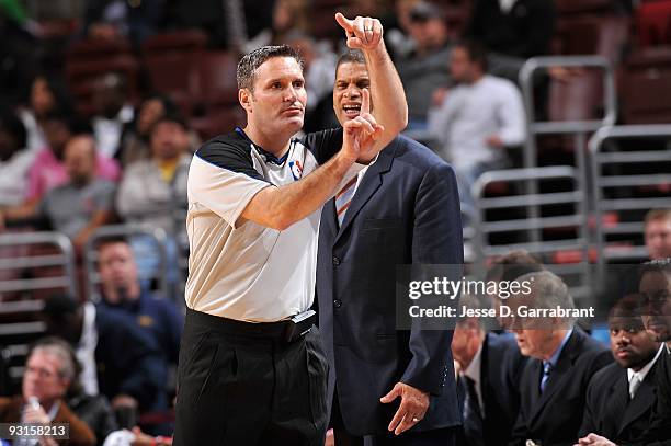 Referee Monty McCutcheon makes a call as head coach Eddie Jordan of the Philadelphia 76ers reacts during a game against the New Jersey Nets on...