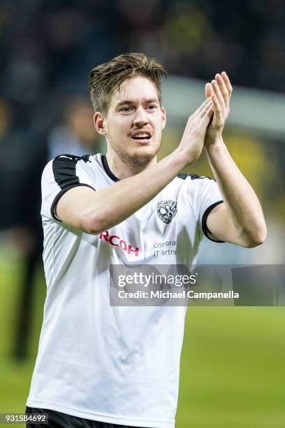 Victor Skold of Orebro SK thanks the visiting supporters during a Swedish Cup quarter final match between AIK and Orebro SK at Friends arena on March...