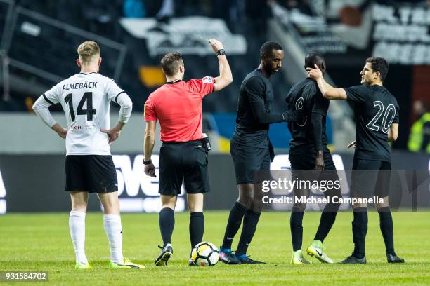 Referee Kristoffer Karlsson shows a yellow card to Enoch Kofi Adu of AIK during a Swedish Cup quarter final match between AIK and Orebro SK at...