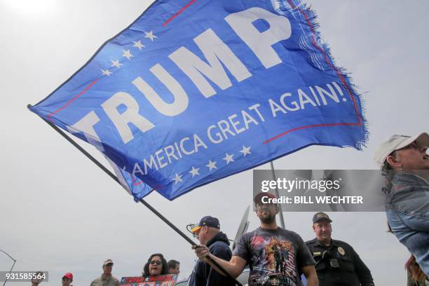 Trump supporter waves a pro-Trump sign during a pro-Trump rally attended by about 500 people in San Diego, California, March 13 where President Trump...