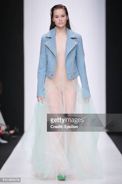 Model walks the runway during the KETIONE fashion show at Mercedes Benz Fashion Week Russia Fall/Winter 2018/19 at Manege on March 13, 2018 in...