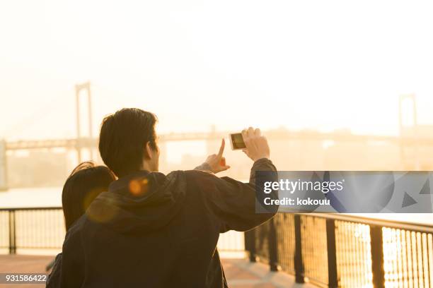 a couple shooting pictures. - back to front stock pictures, royalty-free photos & images