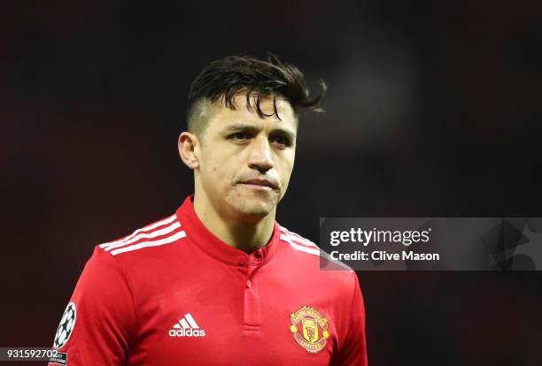 Alexis Sanchez of Manchester United looks dejected in defeat after the UEFA Champions League Round of 16 Second Leg match between Manchester United...