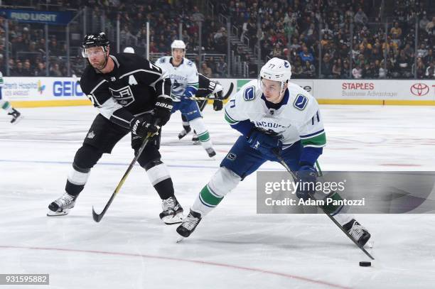 Nikolay Goldobin of the Vancouver Canucks handles the puck against Jeff Carter of the Los Angeles Kings at STAPLES Center on March 12, 2018 in Los...