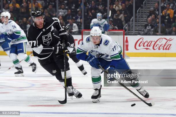 Nikolay Goldobin of the Vancouver Canucks handles the puck against Jeff Carter of the Los Angeles Kings at STAPLES Center on March 12, 2018 in Los...