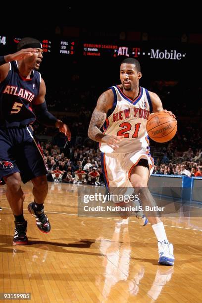 Wilson Chandler of the New York Knicks drives to the basket past Josh Smith of the Atlanta Hawks during the game on November 11, 2009 at Madison...