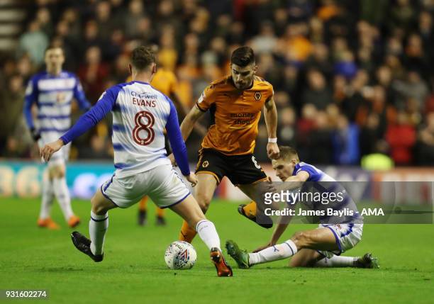Ruben Neves of Wolverhampton Wanderers and David Edwards and George Evans of Reading during the Sky Bet Championship match between Wolverhampton...