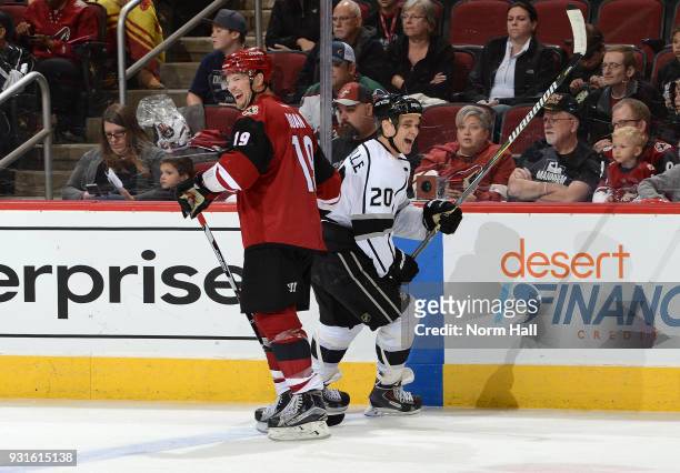 Luc Robitaille of the Los Angeles Kings alumni team and Shane Doan of the Arizona Coyotes alumni team exchange laughs during an exhibition game prior...