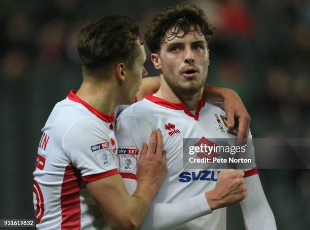 Robbie Muirhead of Milton Keynes Dons celebrates after scoring his sides first goal with team mate Callum Brittain during the Sky Bet League One...