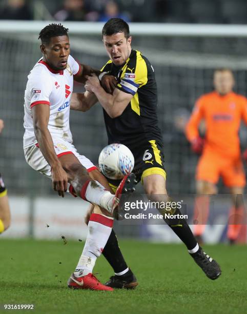 Chuks Aneke of Milton Keynes Dons contests the ball with Richard Wood of Rotherham United during the Sky Bet League One match between Milton Keynes...