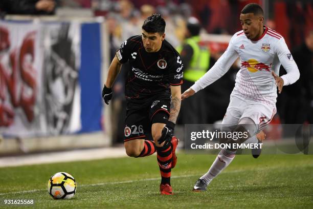 Club Tijuana's Luis Angel Mendoza and New York Red Bulls' Tyler Adams vie for the ball during the Concacaf Champions League 2nd Leg Quarter-final...