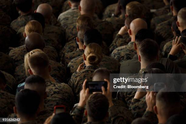 Attendees take photographs during an event with U.S. President Donald Trump, not pictured, at Marine Corps Air Station Miramar in San Diego,...