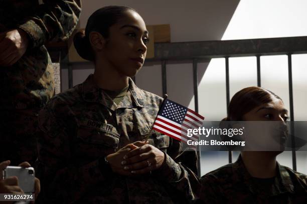 Marine holds an American flag during an event with U.S. President Donald Trump, not pictured, at Marine Corps Air Station Miramar in San Diego,...