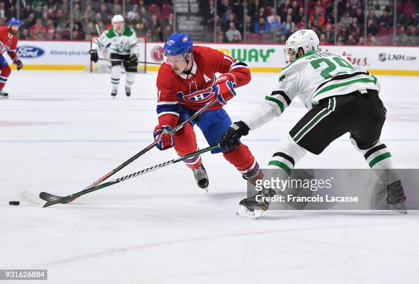 Brendan Gallagher of the Montreal Canadiens skates with the puck against Greg Pateryn of the Dallas Stars in the NHL game at the Bell Centre on March...