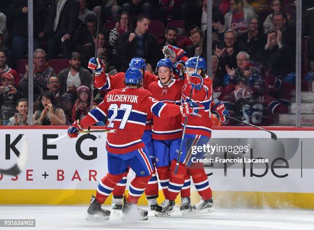 Artturi Lehkonen of the Montreal Canadiens celebrates with teammates after scoring a goal against the Dallas Stars in the NHL game at the Bell Centre...