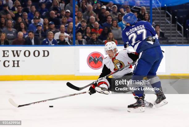 Ryan McDonagh of the Tampa Bay Lightning checks Ryan Dzingel of the Ottawa Senators during the first period at Amalie Arena on March 13, 2018 in...