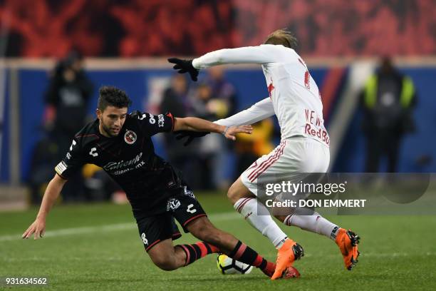 New York Red Bulls' Daniel Royer and Club Tijuana's Ignacio Malcorra vie for the ball during the Concacaf Champions League 2nd Leg Quarter-final...