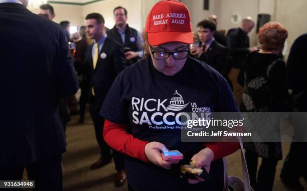Campaign volunteer Chloe Chappell checks early election results at an Election Night event for GOP PA Congressional Candidate Rick Saccone as the...