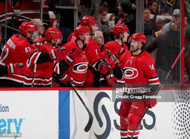 Justin Williams of the Carolina Hurricanes is congratulated by teammates after scoring a goal during an NHL game against the Boston Bruins on March...